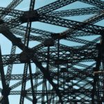 Quebec Bridge - a close up of a metal structure with a blue sky in the background