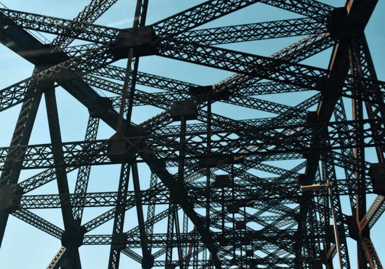 Quebec Bridge - a close up of a metal structure with a blue sky in the background