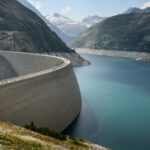 Itaipu Dam - photo of concrete dam in lake near mountains during daytime