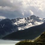 Grande Dixence - a scenic view of a mountain range with a lake in the foreground