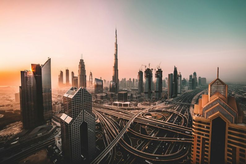 Burj Khalifa - aerial photo of city highway surrounded by high-rise buildings