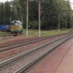 Trans-Siberian Railway - a train traveling down train tracks next to a forest