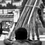 Shard London - grayscale photo of man sitting on the floor