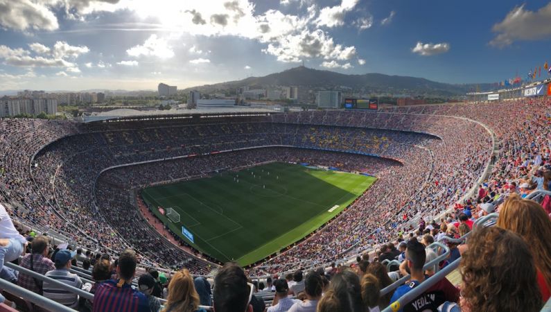 Camp Nou - a stadium full of people watching a soccer game