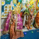 Place Festivals - a group of statues of hindu deities in front of a painting