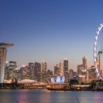 Marina Bay - ferris wheel near city buildings during night time