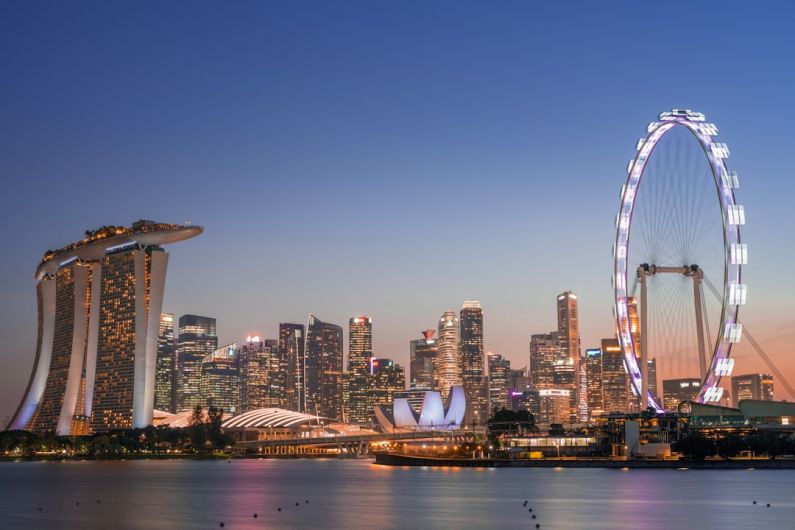 Marina Bay - ferris wheel near city buildings during night time