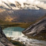 Cliffside Norway - landscape photography of body of water between mountain