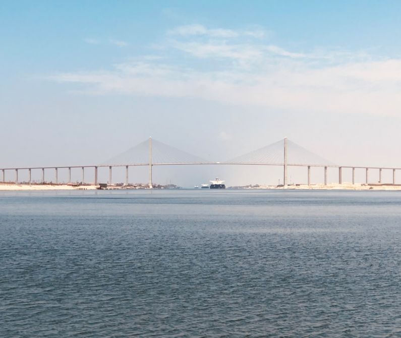 Suez Canal - bridge over the sea under blue sky during daytime