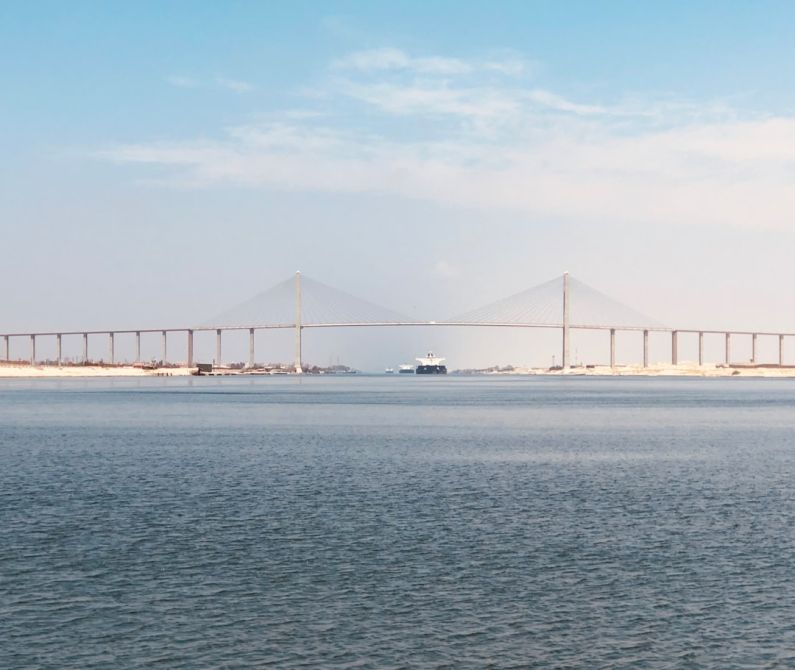 Suez Canal - bridge over the sea under blue sky during daytime