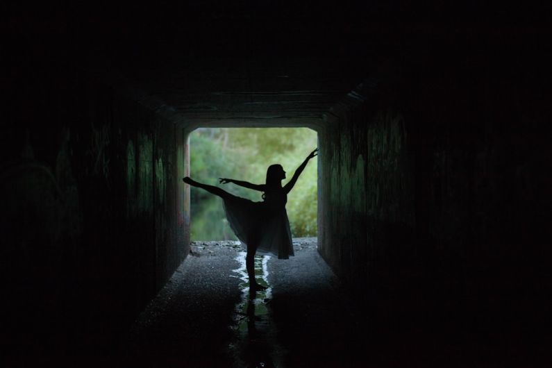 Floating Tunnels - silhouette of woman doing ballet low light photography