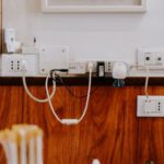 Undersea Cables - white power strip on brown wooden floor