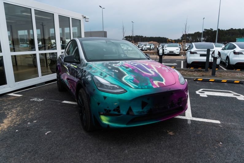 Gigafactory - a colorful car parked in a parking lot