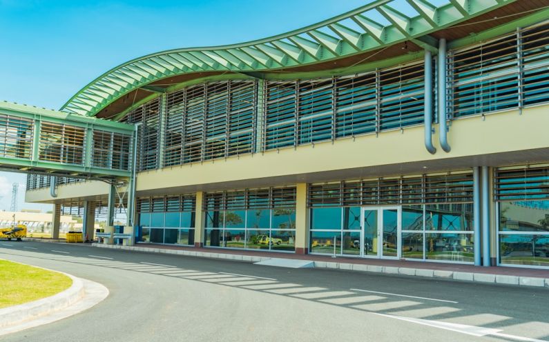 Green Airport - a large building with a green roof and a curved walkway