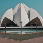 Lotus Temple - white concrete building near body of water during daytime