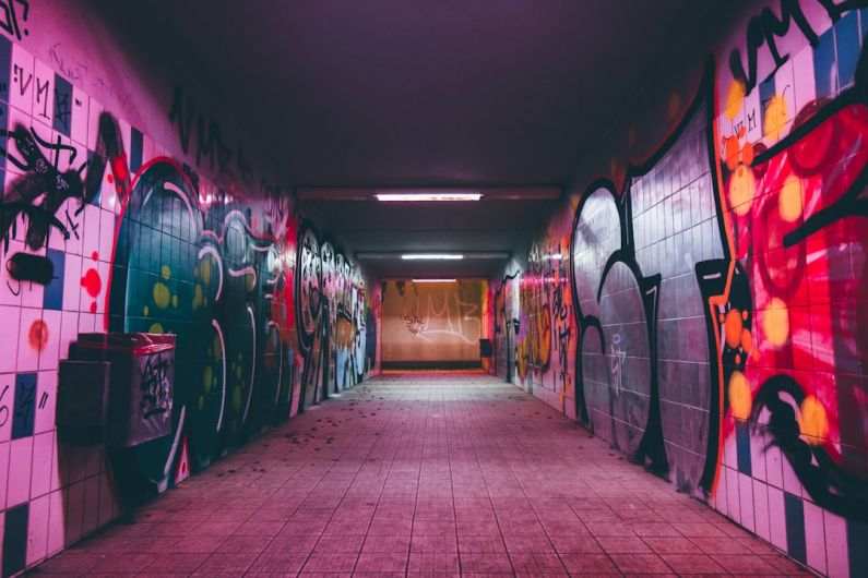 IoT Urban Planning - empty tunnel pathway with graffiti walls