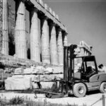 Acropolis Restoration - a black and white photo of a forklift in front of a building