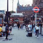 St. Pancras - a group of people walking down a street next to a traffic light