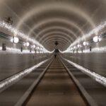 Underwater Tunnel - people walking on hallway with lights turned on during night time