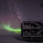 Mariana Observatory - white multi-storey building under starry night and northern lights