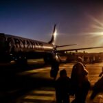 Solar Airport - silhouette of people near plane