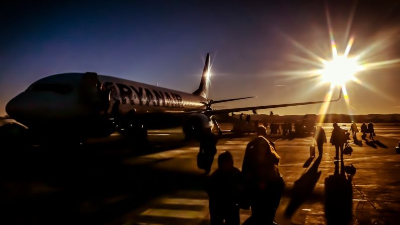 Solar Airport - silhouette of people near plane