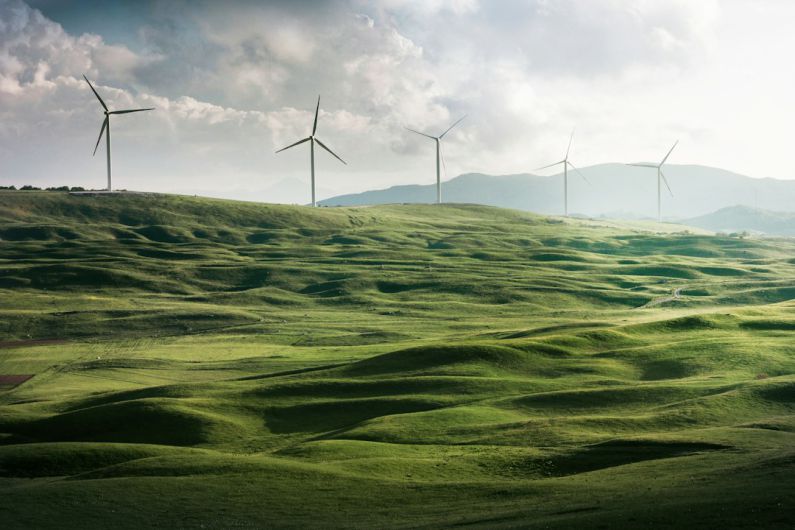 Sustainable Energy - wind turbine surrounded by grass