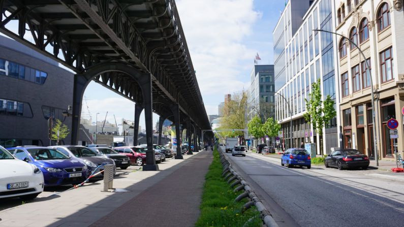 Elevated Bike Lane - cars parked on the side of the road under a bridge