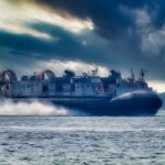 Hovercraft - blue and white ship on sea under cloudy sky during daytime